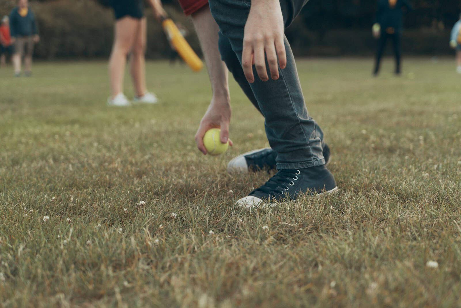 Photo by Ross Sneddon selective focus photography of man holding green baseball